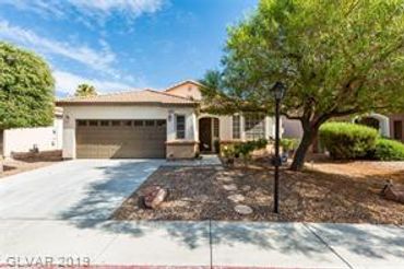 Suburban house with desert landscaping and a two-car garage.