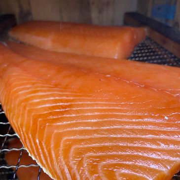 Fresh salmon fillets on a grill.
