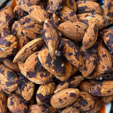 Bowl of almonds with chocolate flakes and salt.