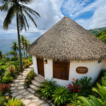 Thatched roof lodge surrounded by lush tropical plants and palm trees.