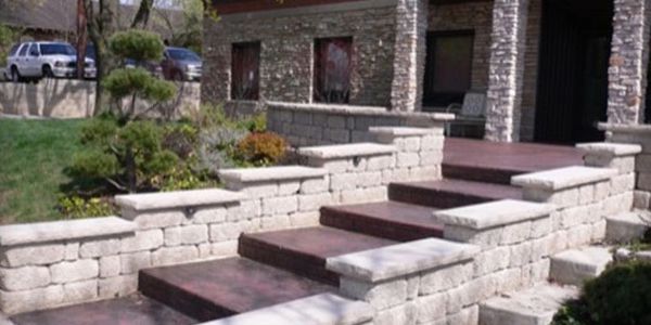 European Fan stamped concrete, brick red color, Manor block sitting and Retaining wall with custom capstone.