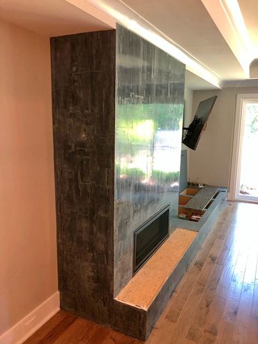 Grey Venetian Plaster around the fireplace of a Cary homeowner.