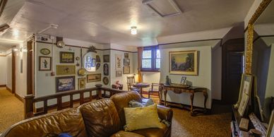 McCleary Hotel Library Landing; Comfy Leather Couch; Table with games: Lots of pictures; big mirror