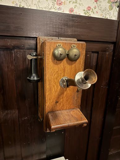 Original telephone; 1912; Fireside room; cutting edge technology; behind manager's desk; room buzzer
