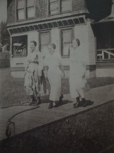 The McCleary Hotel 1912; 3 ladies on the boardwalk; small side porch; garden hose; front porch