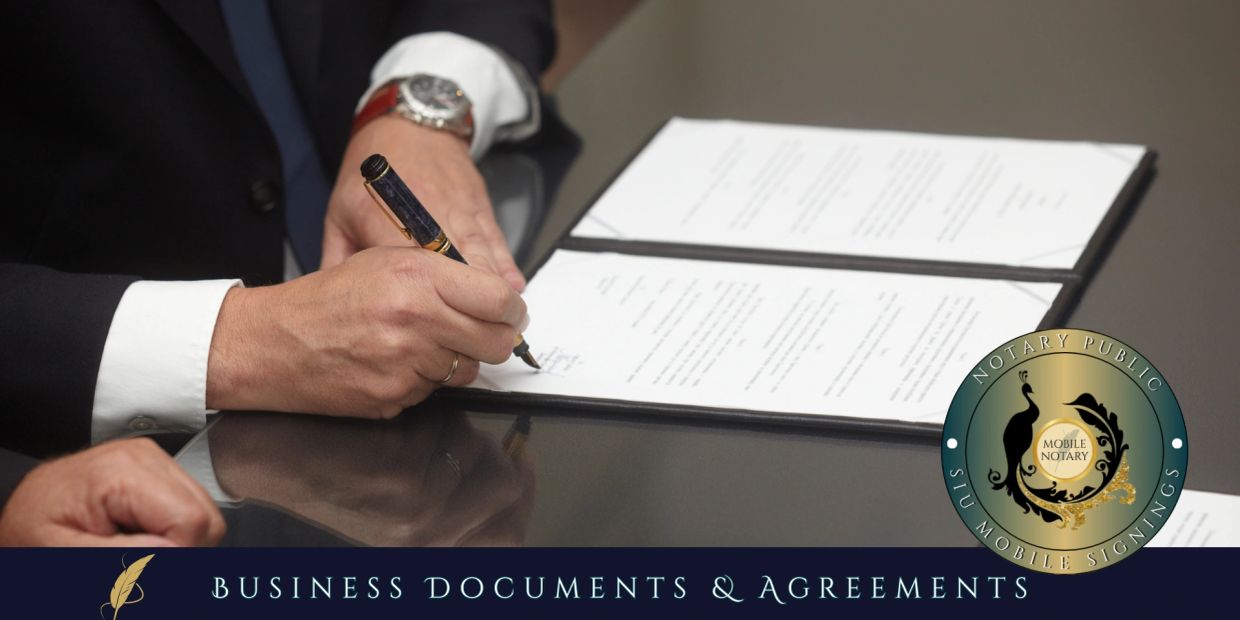 Person signing business documents with a pen.