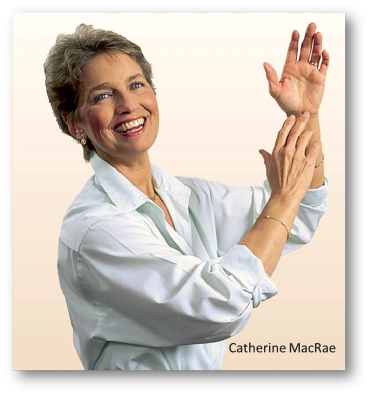 Smiling woman in white shirt demonstrating hand stretches.