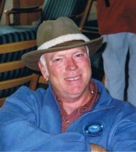 A man wearing a hat, smiling