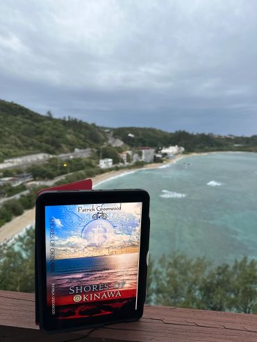 Book titled "Shores of Okinawa" with a scenic beach background.