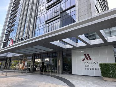 Marriott Taipei hotel entrance with reflective glass facade.