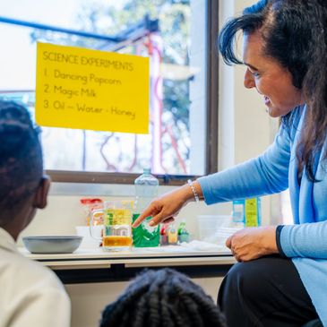 Teacher demonstrates science experiment to children.
