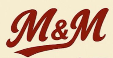 Stylized M&M logo in bold red script.