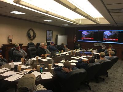 Group attending a meeting or training session in a conference room.