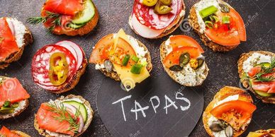 Selection of tapas on a slate serving board.