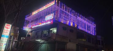 Building lit up with colorful lights advertising English and immigration services.