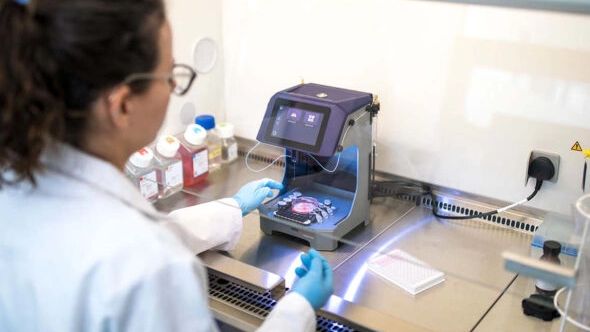 scientist working in a lab with an electronic testing device