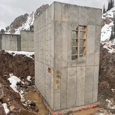 Concrete block setting up on the mountain side for a ski lift.