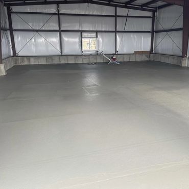 Smooth, flat concrete floor of a steel building.