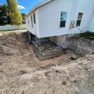 Building a concrete foundation on an existing building.
