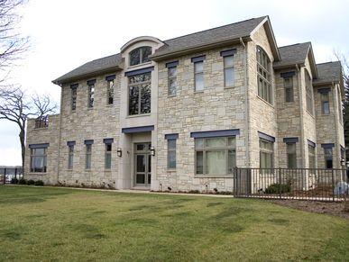large stone home with grey roof