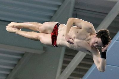 Male diver twists in the air. 