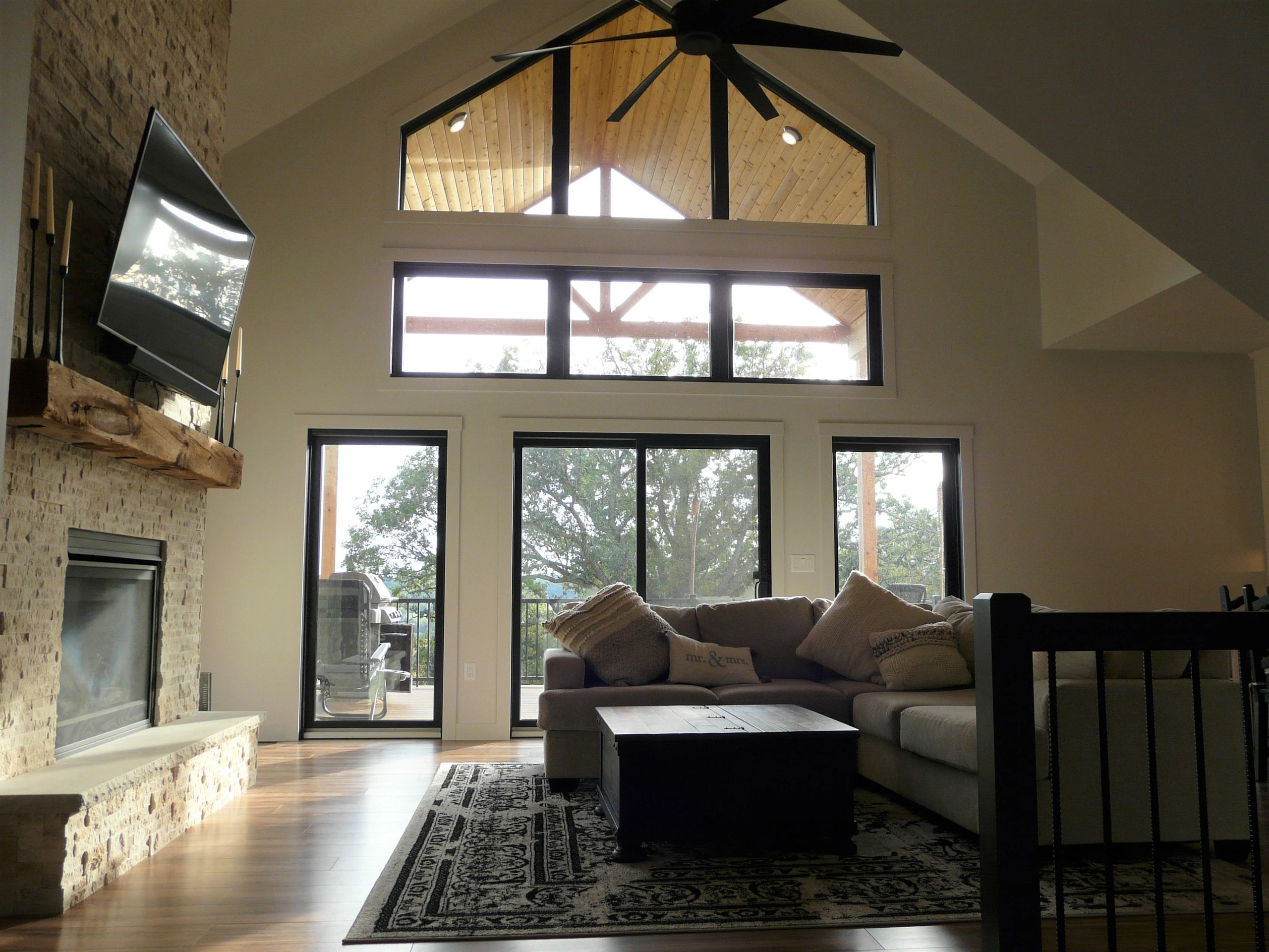 Custom home design of great room with a frame windows and covered deck.