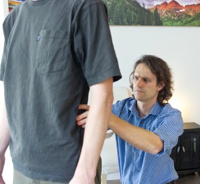 Dr. Leins examining a patient's back.
