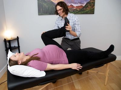 Dr. Leins working with a pregnant woman.