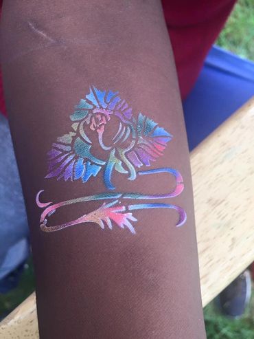 Flower airbrush tattoo on dark skin Flint Michigan
