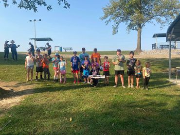 Smiling group of young anglers posing at the Edwardsville Gun Club Kids Fishing Derby.