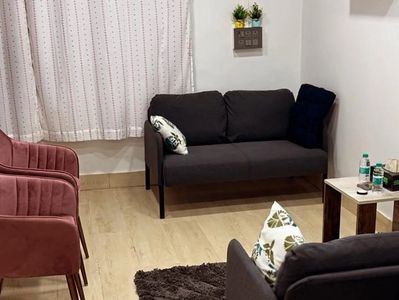 Cozy therapy room with modern chairs and calming decor.