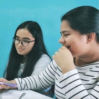 Two students in a small group French lesson at French Language Academy in Singapore