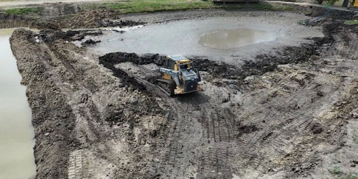 Construction site with bulldozer moving dirt.