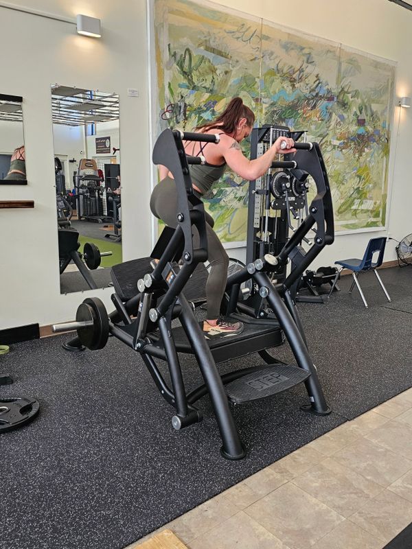 Member doing lateral glute presses on glute press machine.