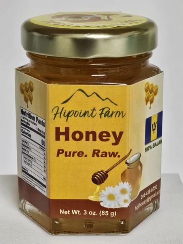 Jar of Hipoint Farm Pure Raw Honey with a golden lid Barbados flag logo and floral design.