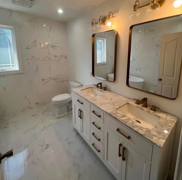 Modern bathroom with marble finish and double sink vanity.