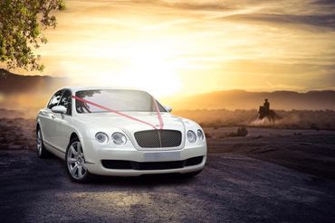 white Bentley wedding car in the sunset