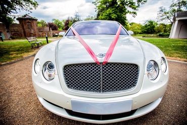 red ribbon on a Bentley wedding car