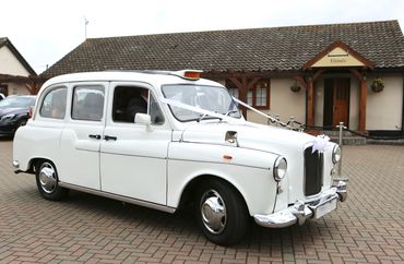 Old London Taxi cab with wedding ribbons on