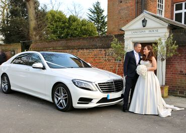 bride + groom standing next to a Mercedes wedding car