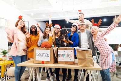 Volunteers celebrating with donation boxes