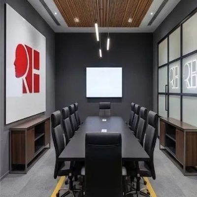 Modern conference room with black chairs and wooden ceiling.