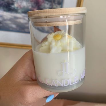 Small glass container with a candle flower