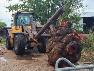 tractor with a large piece of burl