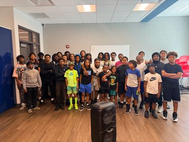 Group photo of diverse kids and teens indoors.