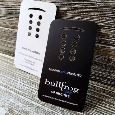 Bullfrog Spas die cut business cards on a wood background