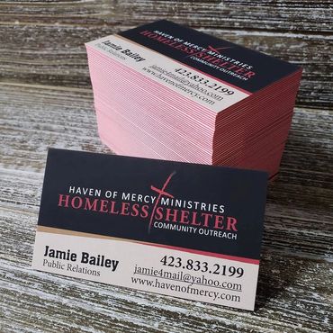 Haven of Mercy Homeless Shelter business cards on a wood background