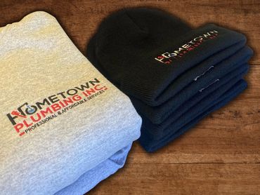 Gray sweatshirt and black knit winter hat with the Hometown Plumbing logo