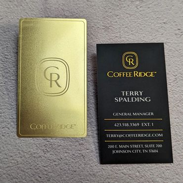2 business cards, a gold metal card and a gold foil lettering card, for Coffee Ridge.