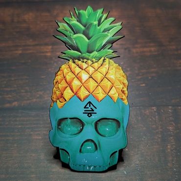 A custom die-cut business card in the shape of a skull with a pineapple on top of its head.